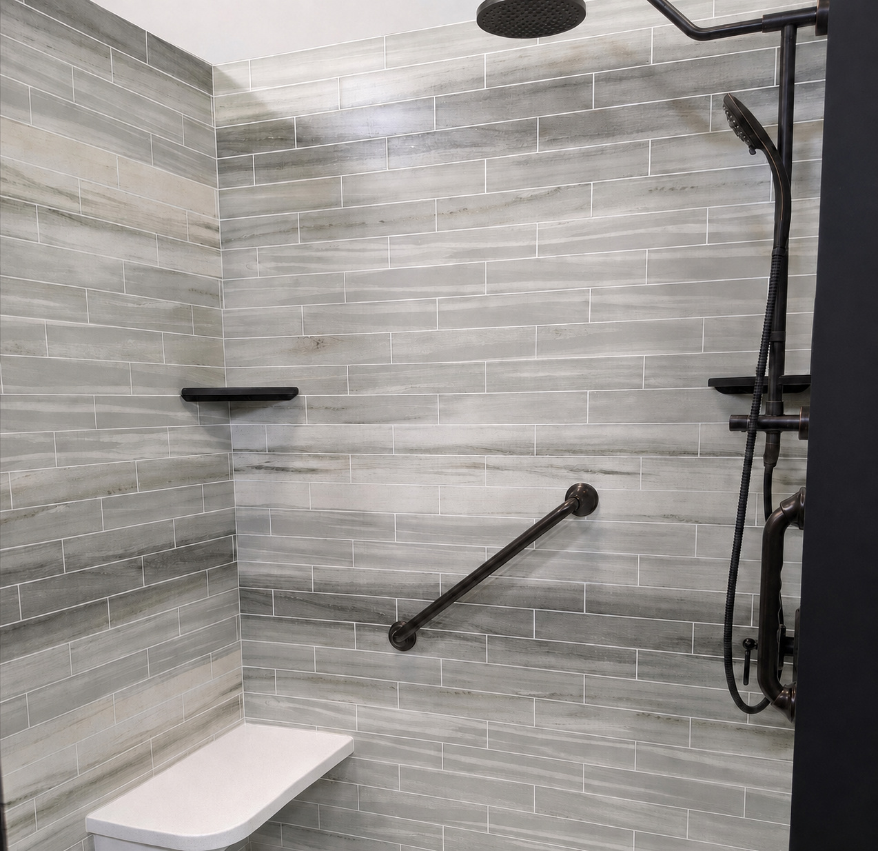 Walk-in shower with gray patterned walls and oil-rubbed bronze fixtures