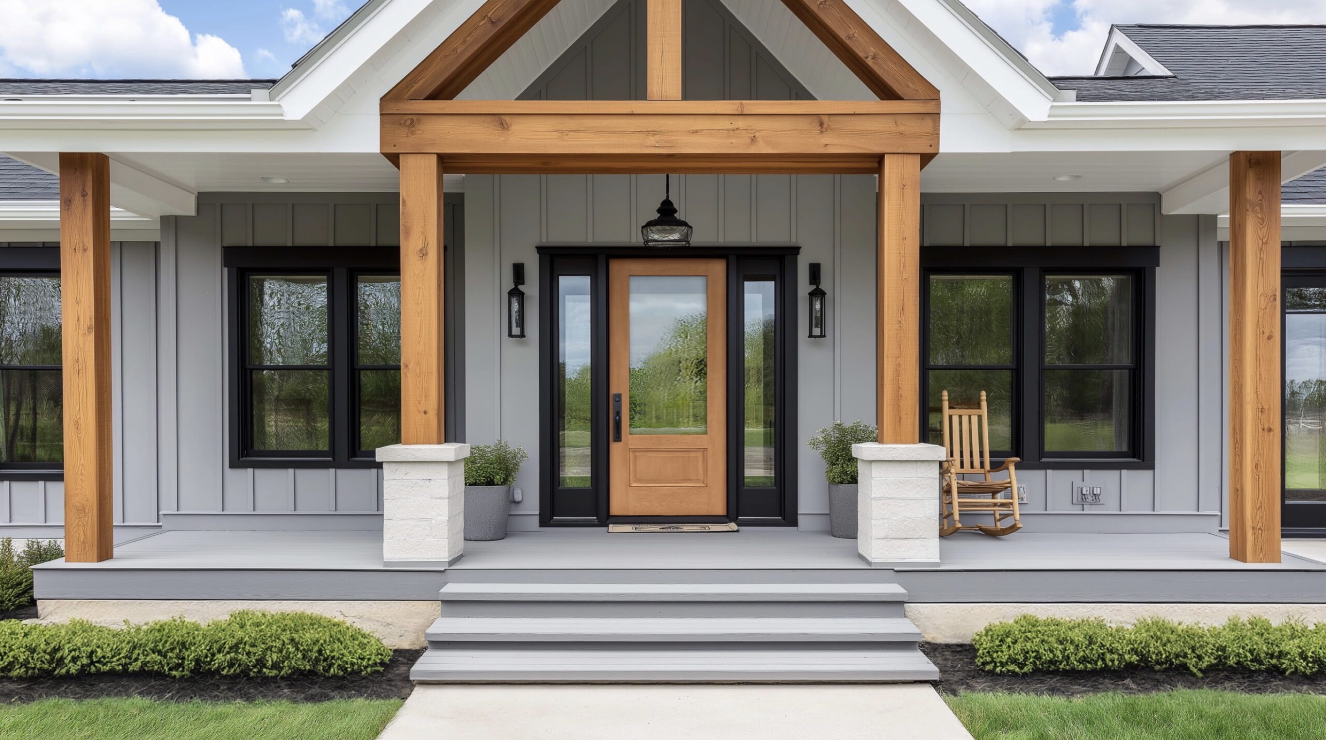 Warm wood entry door framed by black windows